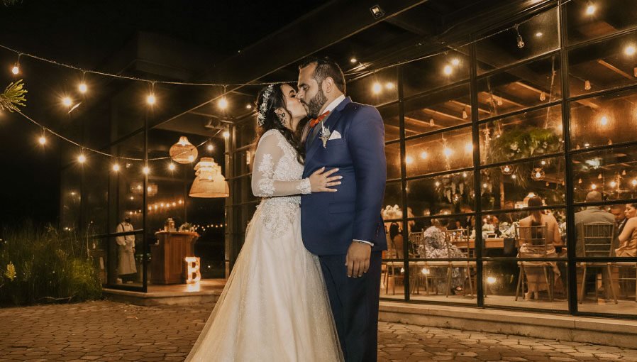 Pareja de esposos en su banquete de bodas celebrando con sus invitados